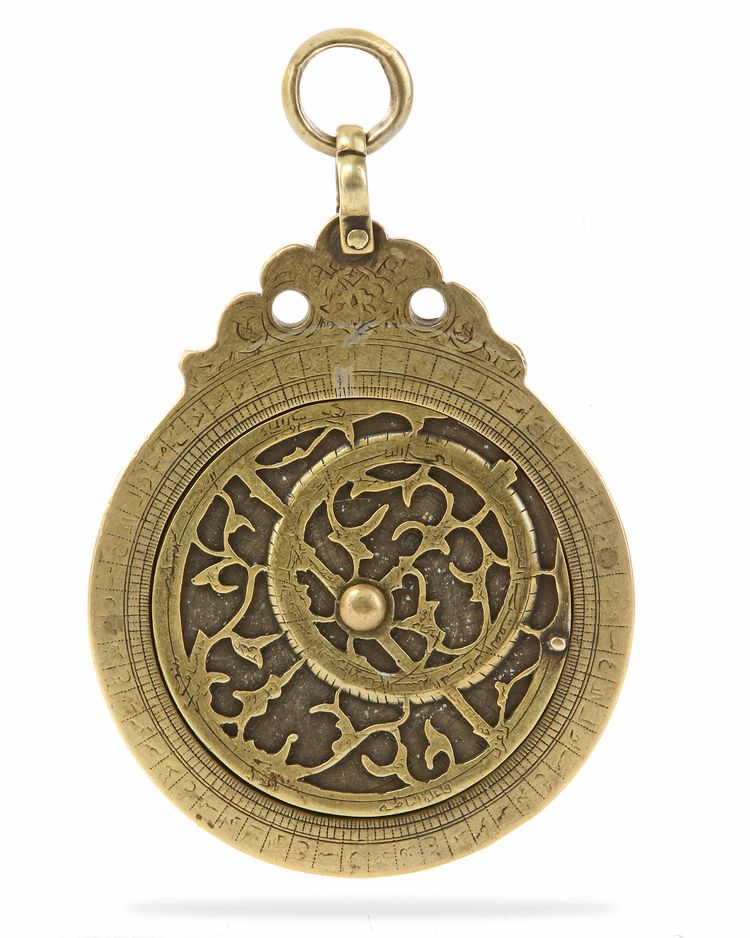 A BRASS ASTROLOBE SIGNED BY MUHAMMAD MUQIM IBN 'ISA IBN AL-HADDAD, LAHORE, DATED 1051 AH/1641-42 AD