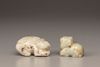 A creamy jade water buffalo and a celadon and russet jade Buddhist lion