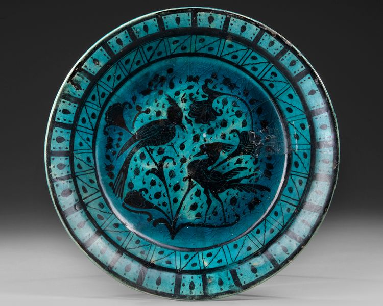 A RAQQA TURQUOISE-GLAZED POTTERY DISH, SYRIA, EARLY 13TH CENTURY