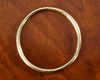 AN 18 CARAT YELLOW GOLD PLAIN HINGED SLAVE BANGLE