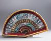 A Chinese Cantonese silk and paper fan with black lacquer guardsticks