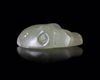 A NEAR EASTERN SEAL IN GREEN CALCITE IN THE FORM OF A LION'S HEAD, 3RD MILLENNIUM BC