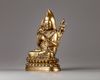 A Sino-Tibetan gilt bronze figure of a Lama