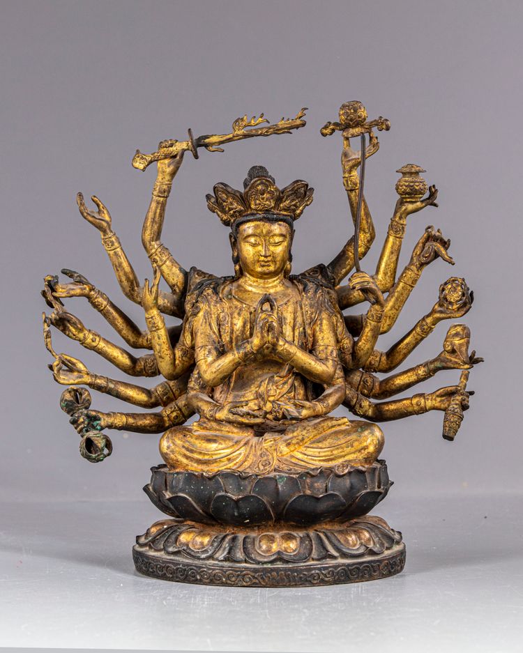A MULTI-ARMED GILT CHINESE BRONZE FIGURE OF GUANYIN