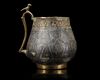 A VERY RARE AND IMPORTANT EARLY ISLAMIC PARCEL-GILT CUP