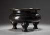 A large Chinese bronze tripod censer