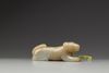 A celadon and russet jade carving of a hound