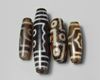 A group of four Tibetan dzi beads
