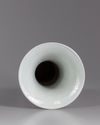 A Chinese iron-red-ground blue and white 'dragon and lotus' vase, gu