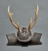 A sword stand (katanakake) in the shape of a black wooden hoshikabuto-helmet