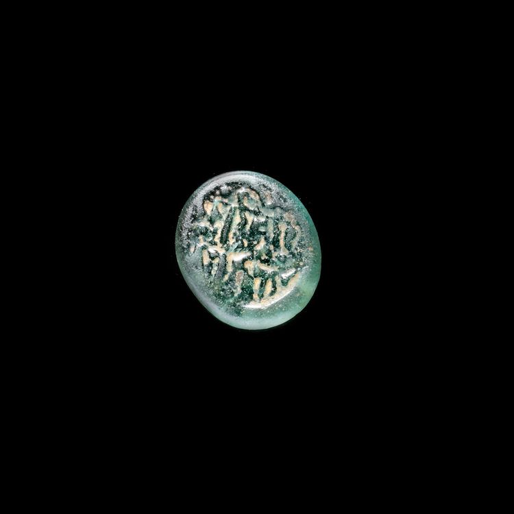 A FATIMID GLASS WEIGHT, AL-HAKIM BI-AMR ALLAH (386AH-411AH/ 996AD-1021AD)