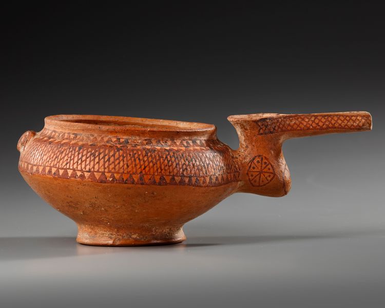 AN AMLASH TERRACOTTA PAINTED SPOUTED VESSEL, CIRCA EARLY 1ST MILLENNIUM B.C.