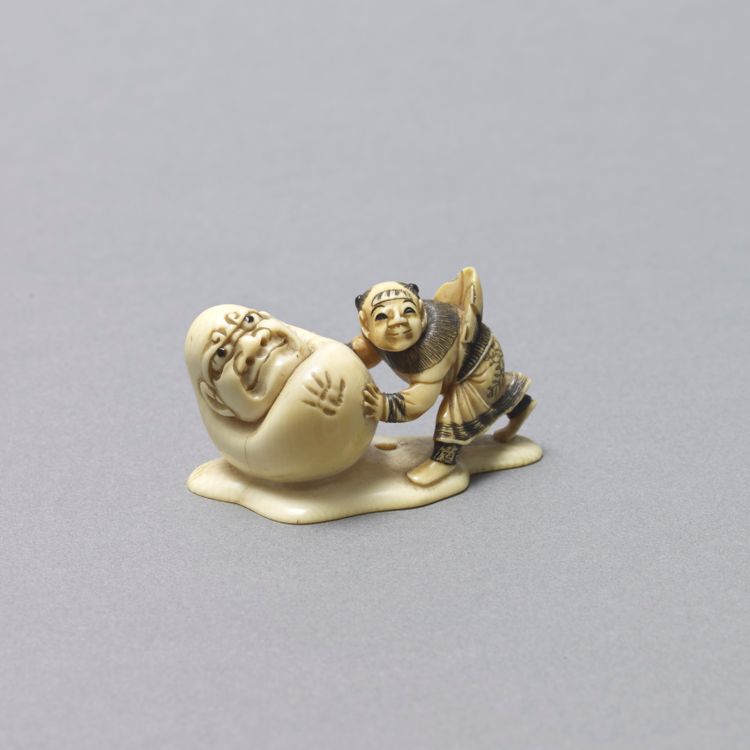 Ivory Netsuke of a Karako and Yuki-Daruma