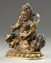 A Sino-Tibetan gilt bronze figure of Jambhala
