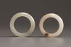 A Chinese white jade archers ring and a very pale celadon jade archers ring