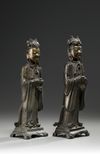 A pair of Chinese parcel gilt bronze standing scholars