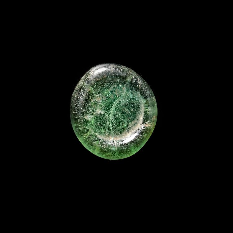 A FATIMID GLASS WEIGHT OF HALF DINAR, EGYPT AL-AZIZ BILLAH ( 364-386AH/ 975-996 AD)
