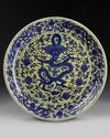 A massive Chinese yellow-glazed blue and white dragon charger