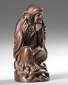 A CHINESE WOOD CARVING OF A LOHAN, 20TH CENTURY