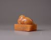 A Chinese yellow soapstone 'tiger' seal