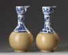 A pair of Chinese blue and white and cafe-au-lait glazed ewers