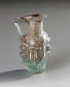A SMALL GLASS EWER WITH MASK-LIKE RELIEF