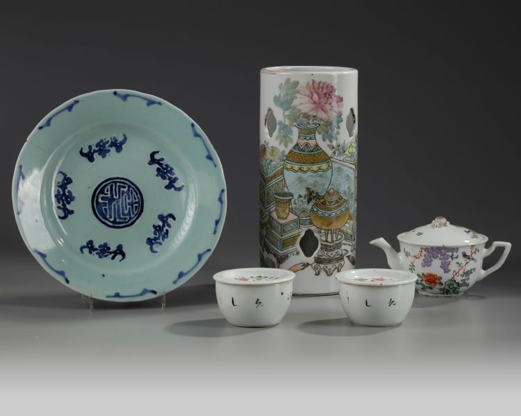 A Chinese famille rose hatstand, a famille rose three-piece tea set, and a celadon-ground blue and white dish