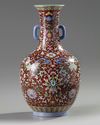 A Chinese red-ground famille rose bottle vase