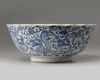 A Chinese blue and white foliate-rimmed 'nine dragon' bowl