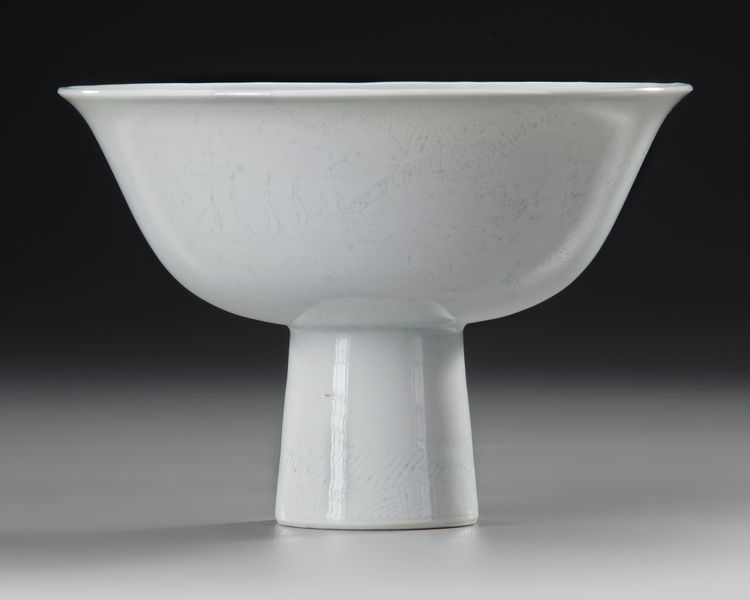 A CHINESE WHITE-GLAZED ANHUA DRAGON STEM CUP, EARLY 18TH CENTURY