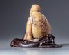 A Chinese soapstone  figure with a zitan wooden stand
