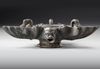 A ROMAN BRONZE THREE-NOZZLED OIL LAMP WITH THEATRE MASK AND ROSETTES AS DECORATION, CIRCA 1ST-2ND CENTURY A.D.