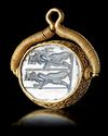 AN ACHAEMENID BLUE CHALCEDONY SEAL IN GOLD MOUNT, 5TH CENTURY BC