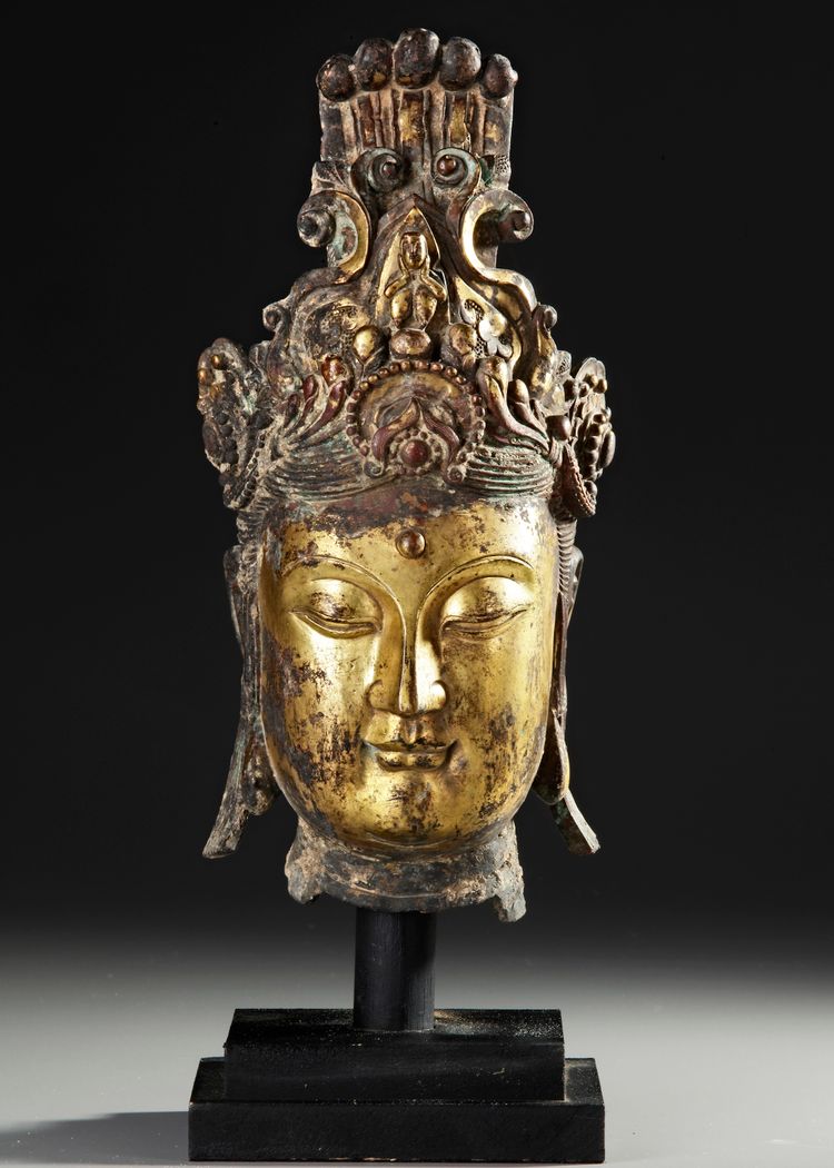 A LARGE GILT BRONZE HEAD OF GUANYIN, MING DYNASTY OR LATER