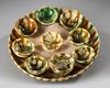 A CHINESE SANCAI GLAZED TRAY AND NINE CUPS, TANG DYNASTY (618-906 AD)
