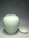 A PAIR OF CHINESE CELADON-GLAZED JARS AND COVERS