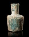A LIGHT LIME GREEN CUT GLASS BOTTLE, PERSIA, CIRCA 9TH CENTURY