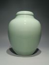 A PAIR OF CHINESE CELADON-GLAZED JARS AND COVERS