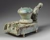 A CHINESE GREEN-GLAZED POTTERY STOVE WITH A DRAGON CHIMNEY