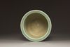 A Chinese celadon glazed tripod censer