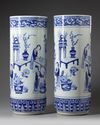 A pair of large blue and white umbrella stands