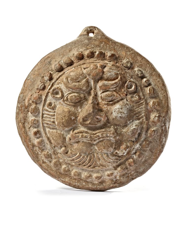 A SELJUK FIGURAL TERRACOTTA TILE ANTEFIX, 12TH CENTURY