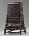 A Chinese gilt bronze table clock in a hongmu case and stand