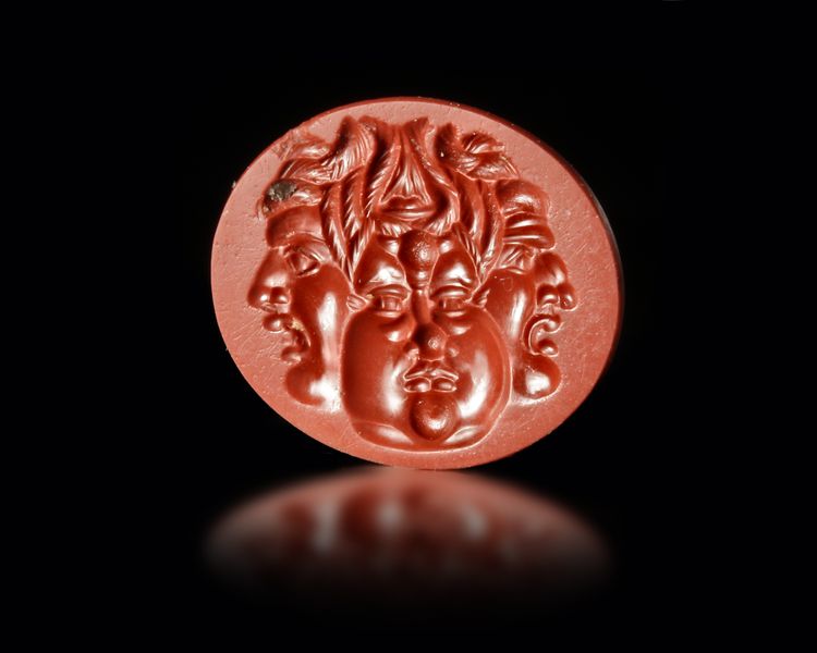 A RED JASPER INTAGLIO WITH A GRYLLOS WITH FOUR HEADS, ROMAN 1ST CENTURY AD