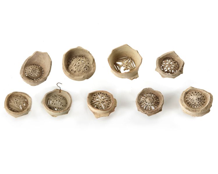 A GROUP OF NINE FATIMID UNGLAZED POTTERY WATER FILTERS, EGYPT, 10TH -11TH CENTURY