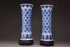 A pair of blue and white trumpet vases