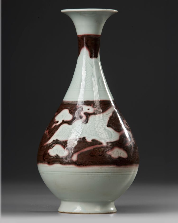 A CHINESE COPPER RED 'PHOENIX' PEAR-SHAPED VASE, YUAN DYNASTY OR LATER
