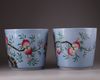A pair of Chinese blue-ground famille rose 'nine peach' jardinieres