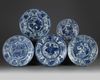 Four Chinese blue and white 'Kraak porcelain' chargers and a bowl