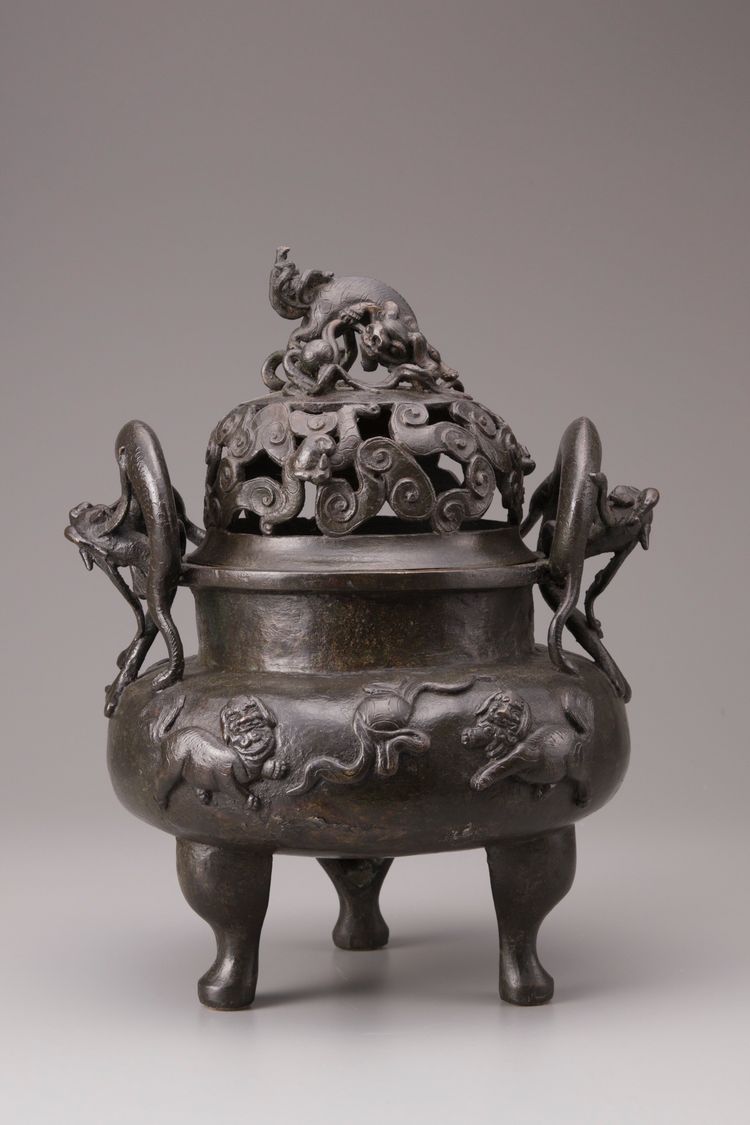 A Chinese bronze tripod censer and cover